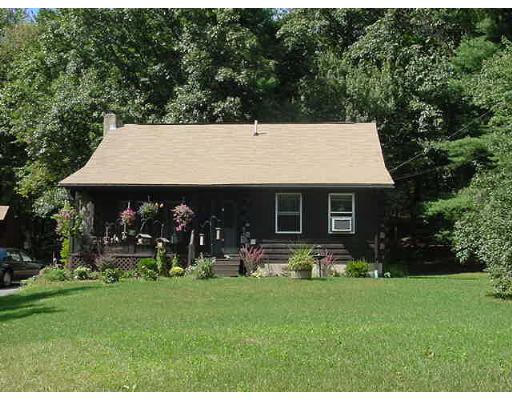 89 Cutler Road Warren, MA 01083 - Photo 2 of 2 a front view of house with yard and outdoor seating