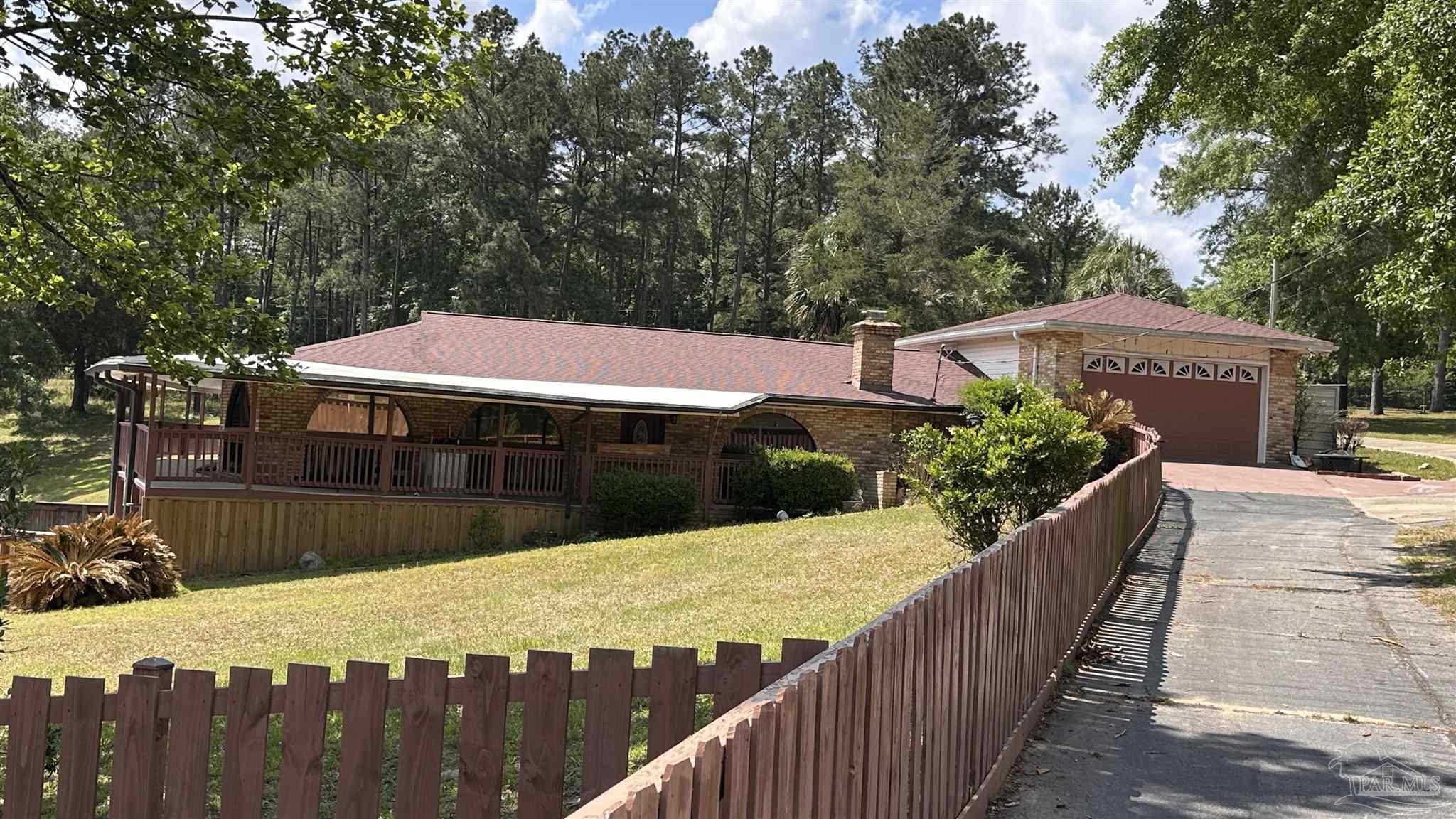 a view of a balcony and yard with wooden fence