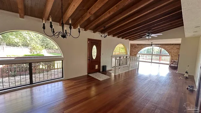 a view of hallway with wooden floor and door