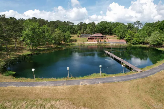 a view of a lake with a yard and a wooden floor