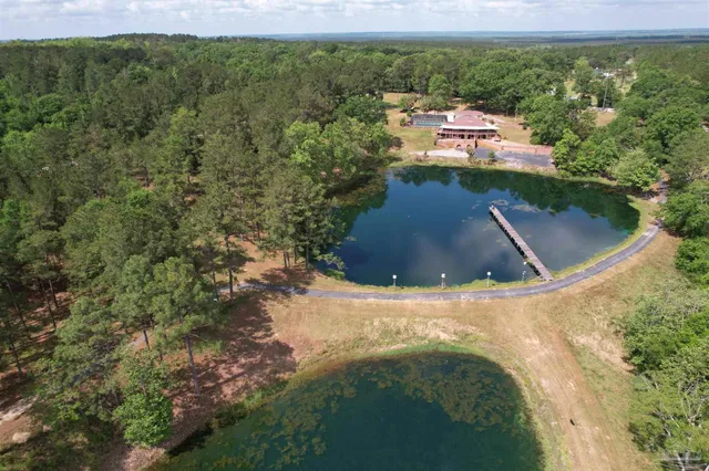 a view of a house with a yard and lake view
