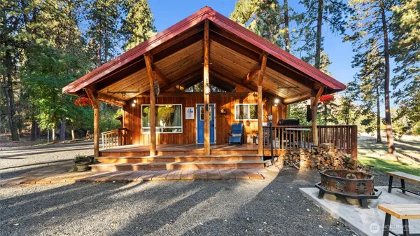 a view of a house with backyard and sitting area