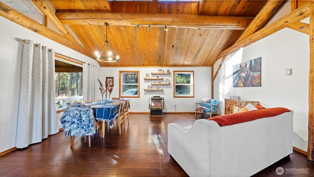 a living room with furniture a wooden floor and next to a window