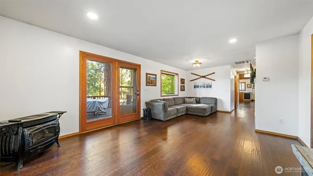 a bedroom with furniture and a wooden floor
