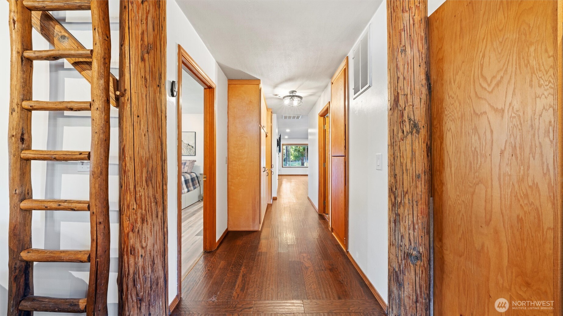 106 Wolf Ridge Lane Dayton, WA 99328 - Photo 15 of 40 a view of a hallway with wooden floor and windows with curtains
