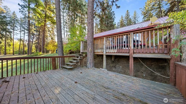 a view of a wooden deck and a backyard