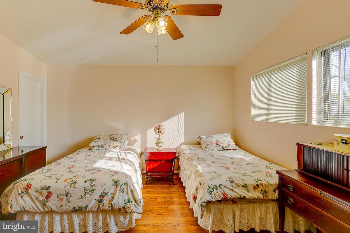 6206 Ivymount Road Baltimore, MD 21209 - Photo 11 of 25 a bedroom with a bed and a chandelier