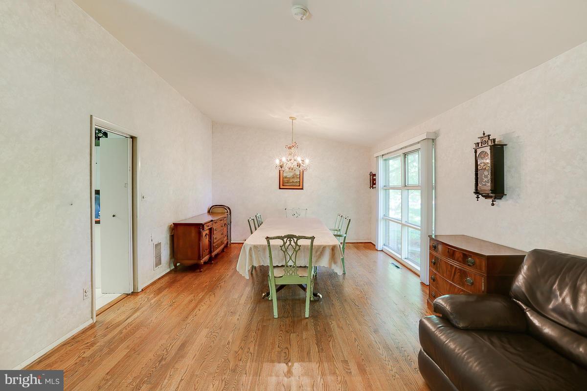 6206 Ivymount Road Baltimore, MD 21209 - Photo 7 of 25 a living room with furniture and a wooden floor