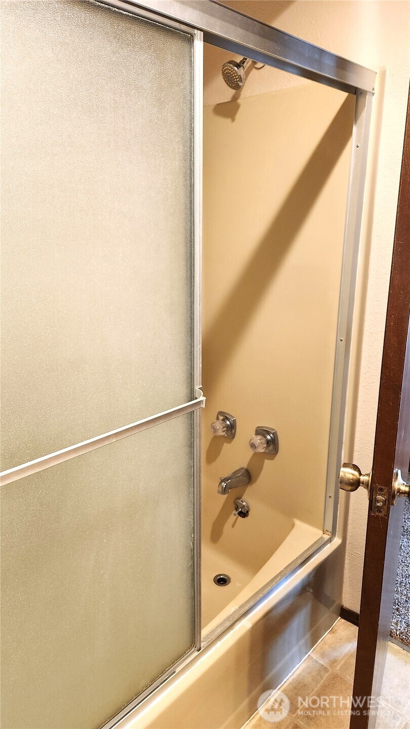 5556 Salish Road Blaine, WA 98230 - Photo 15 of 40 a bathroom with a shower and a bath tub