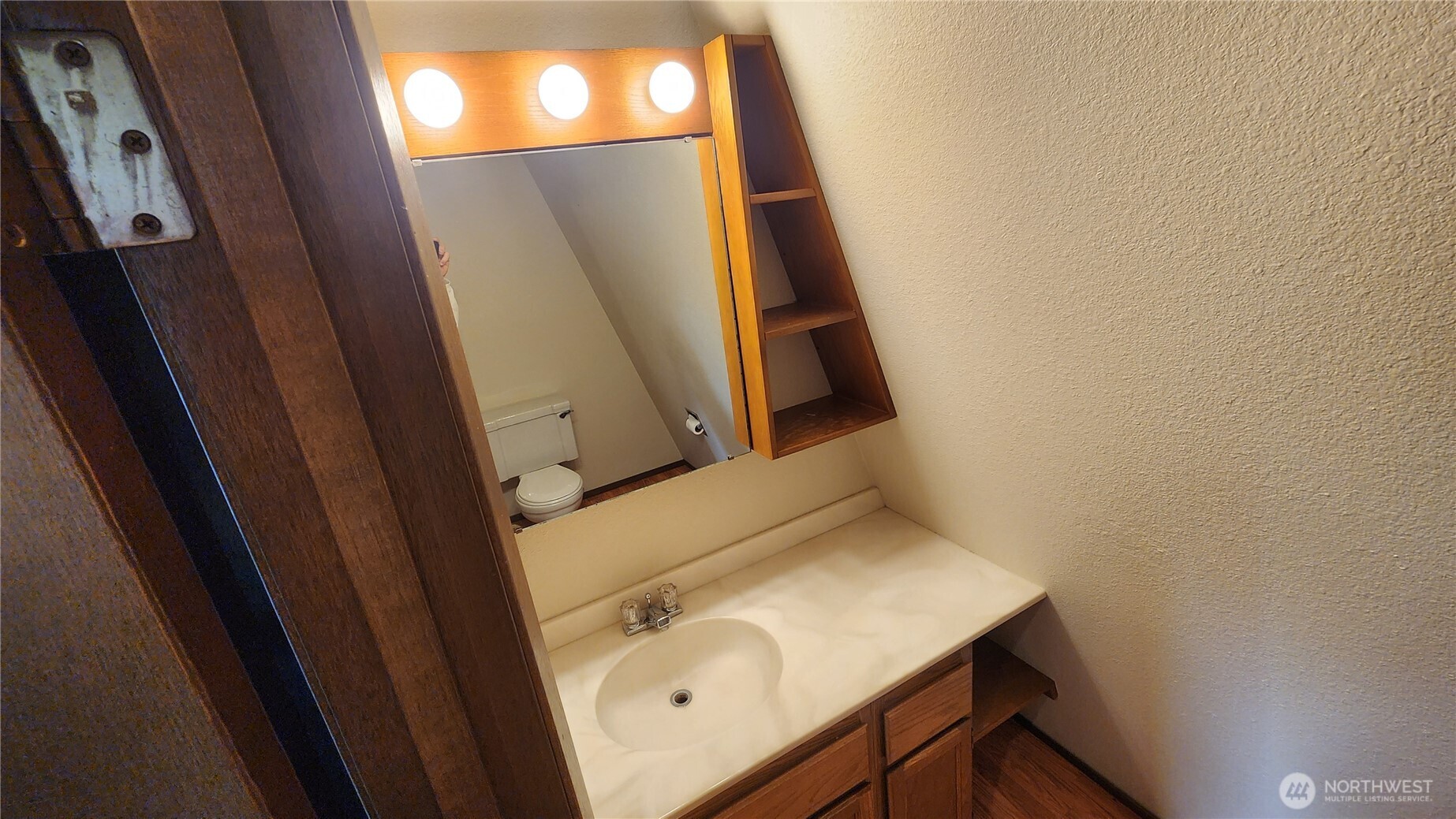 5556 Salish Road Blaine, WA 98230 - Photo 26 of 40 a bathroom with a sink and mirror with window