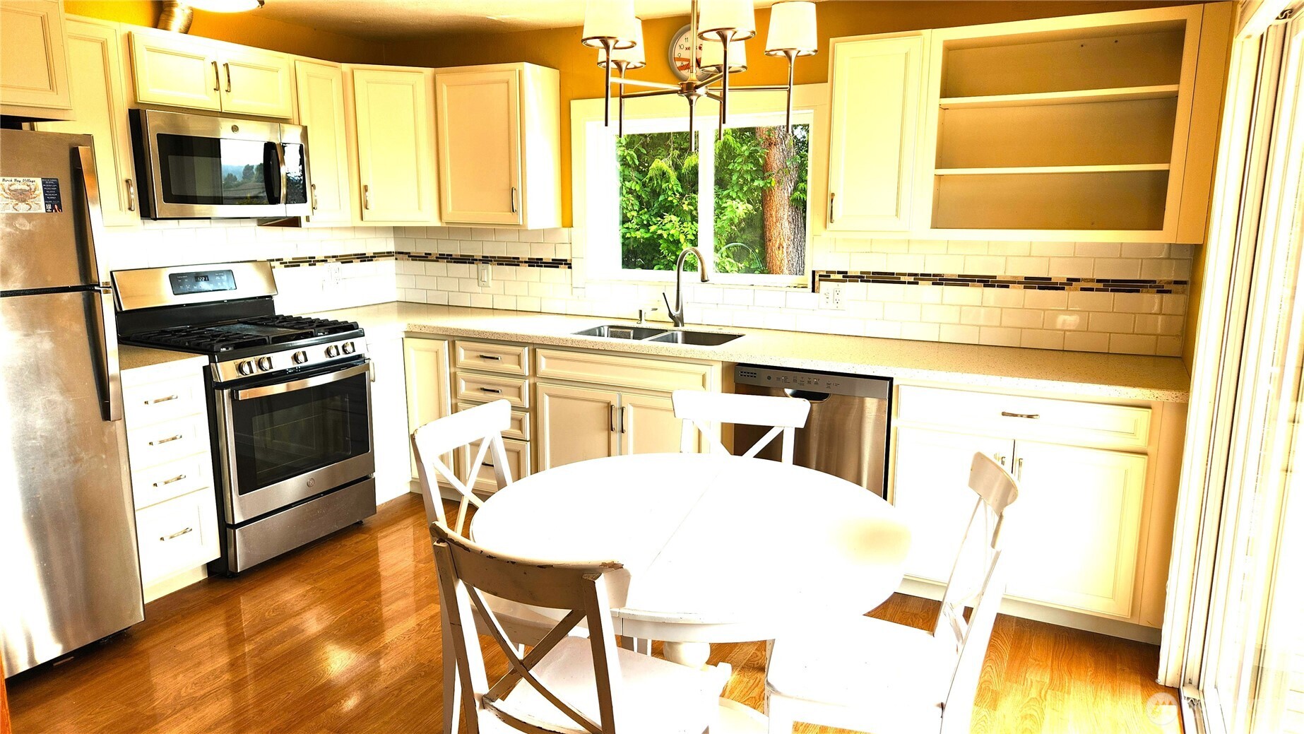 5556 Salish Road Blaine, WA 98230 - Photo 6 of 40 a kitchen with a stove a sink and a microwave