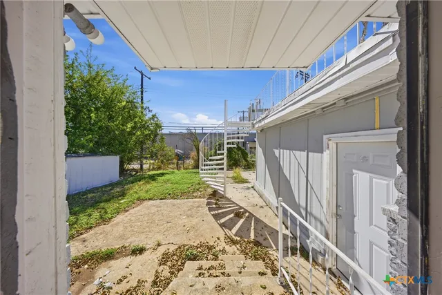 a view of a backyard with sitting area