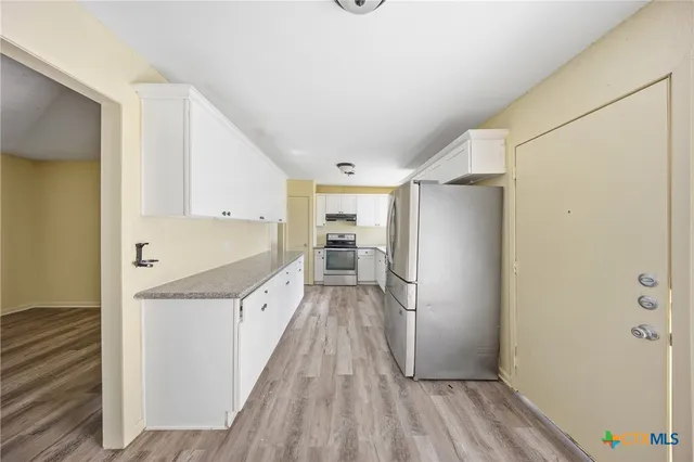 a view of a kitchen from the hallway