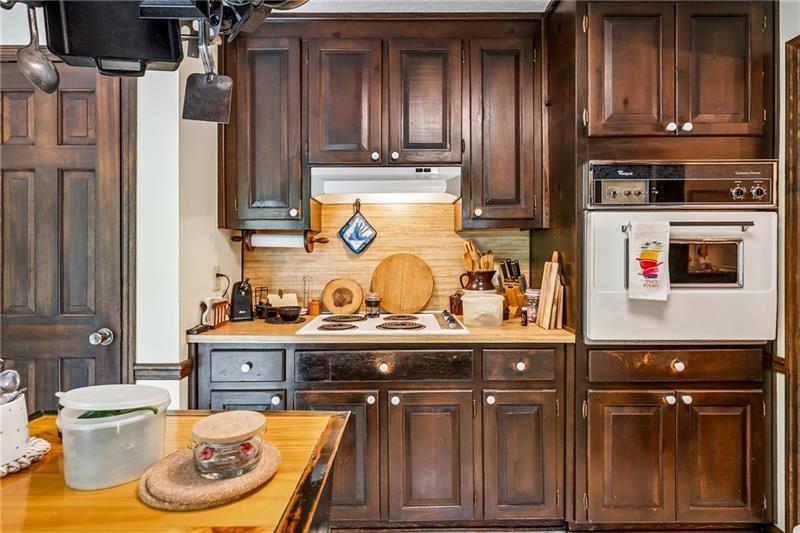 315 Rhine Road Southeast White, GA 30184 - Photo 11 of 59 a kitchen with stainless steel appliances granite countertop a sink and wooden cabinets