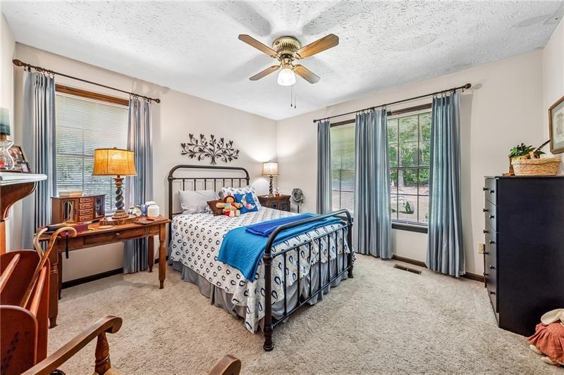 315 Rhine Road Southeast White, GA 30184 - Photo 16 of 59 a bedroom with a bed couch and a window