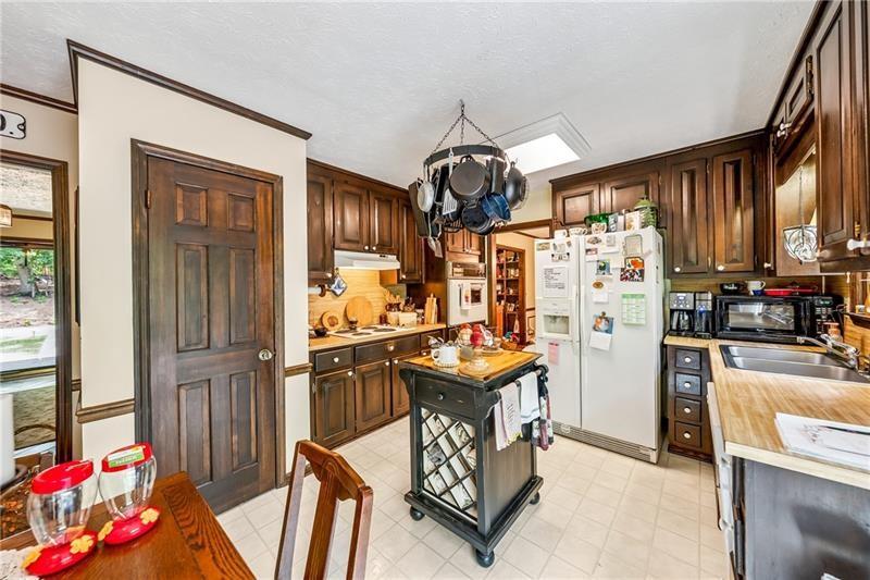 315 Rhine Road Southeast White, GA 30184 - Photo 10 of 59 a kitchen that has a lot of cabinets refrigerator oven and a sink