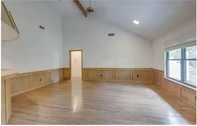 wooden floor in an empty room with a window