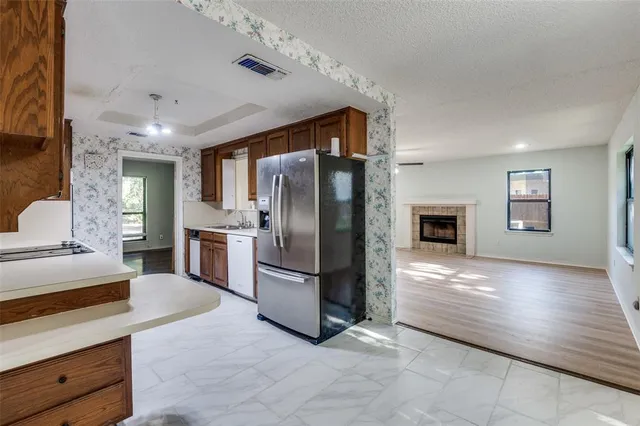 a kitchen with stainless steel appliances a refrigerator and a stove
