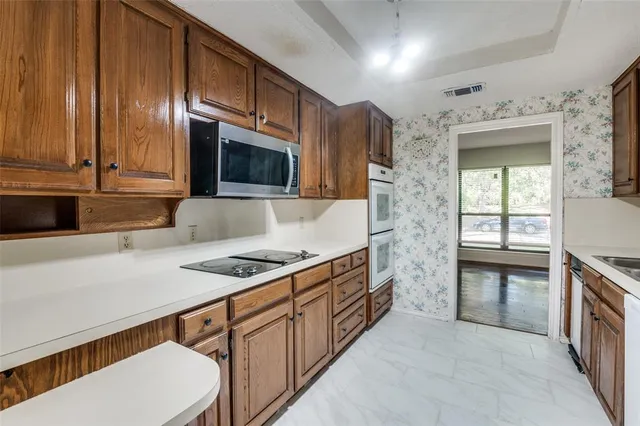 a kitchen with stainless steel appliances granite countertop a sink stove and cabinets
