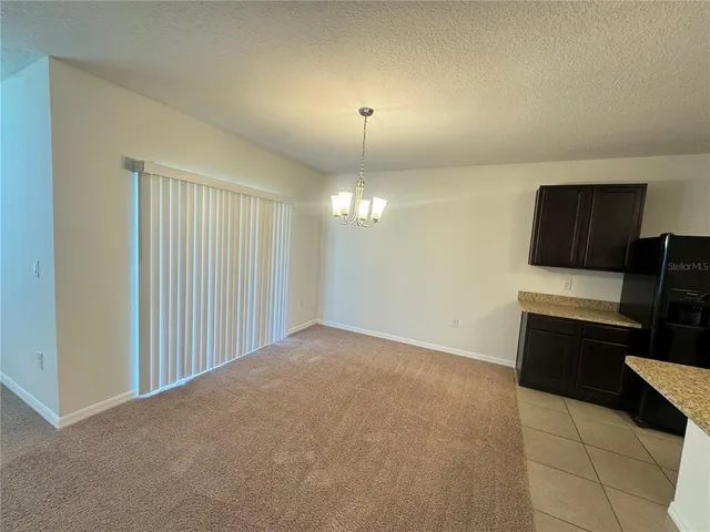 a view of kitchen with furniture and a ceiling fan