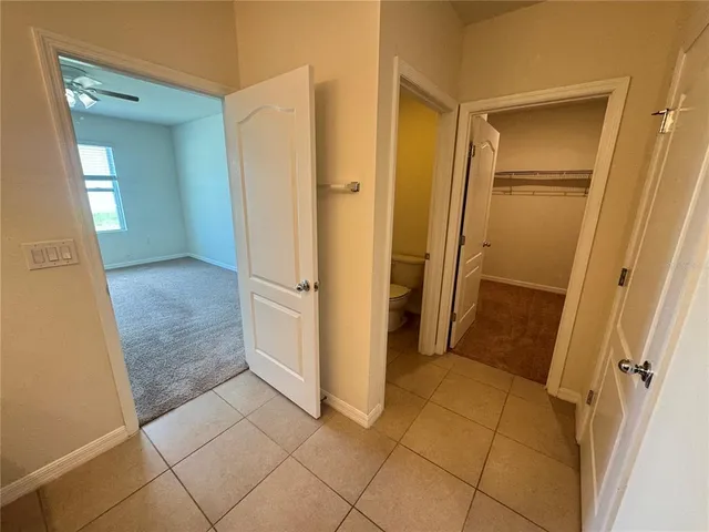 a view of entryway with white walls and refrigerator
