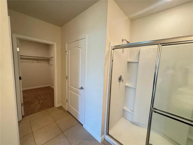 a bathroom with a shower and a glass door