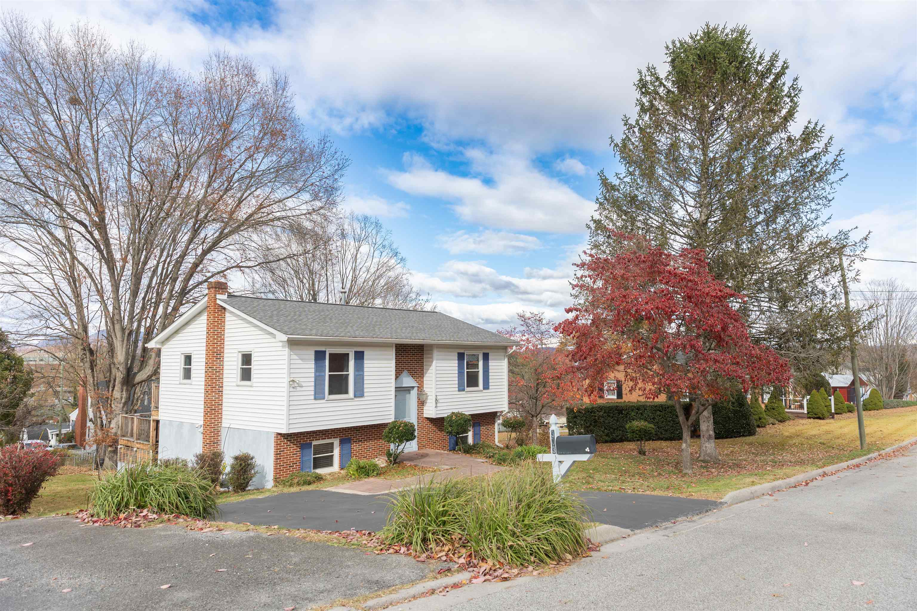 303 Summit Street Lexington, VA 24450 - Photo 2 of 58 a front view of a house with a yard and garage