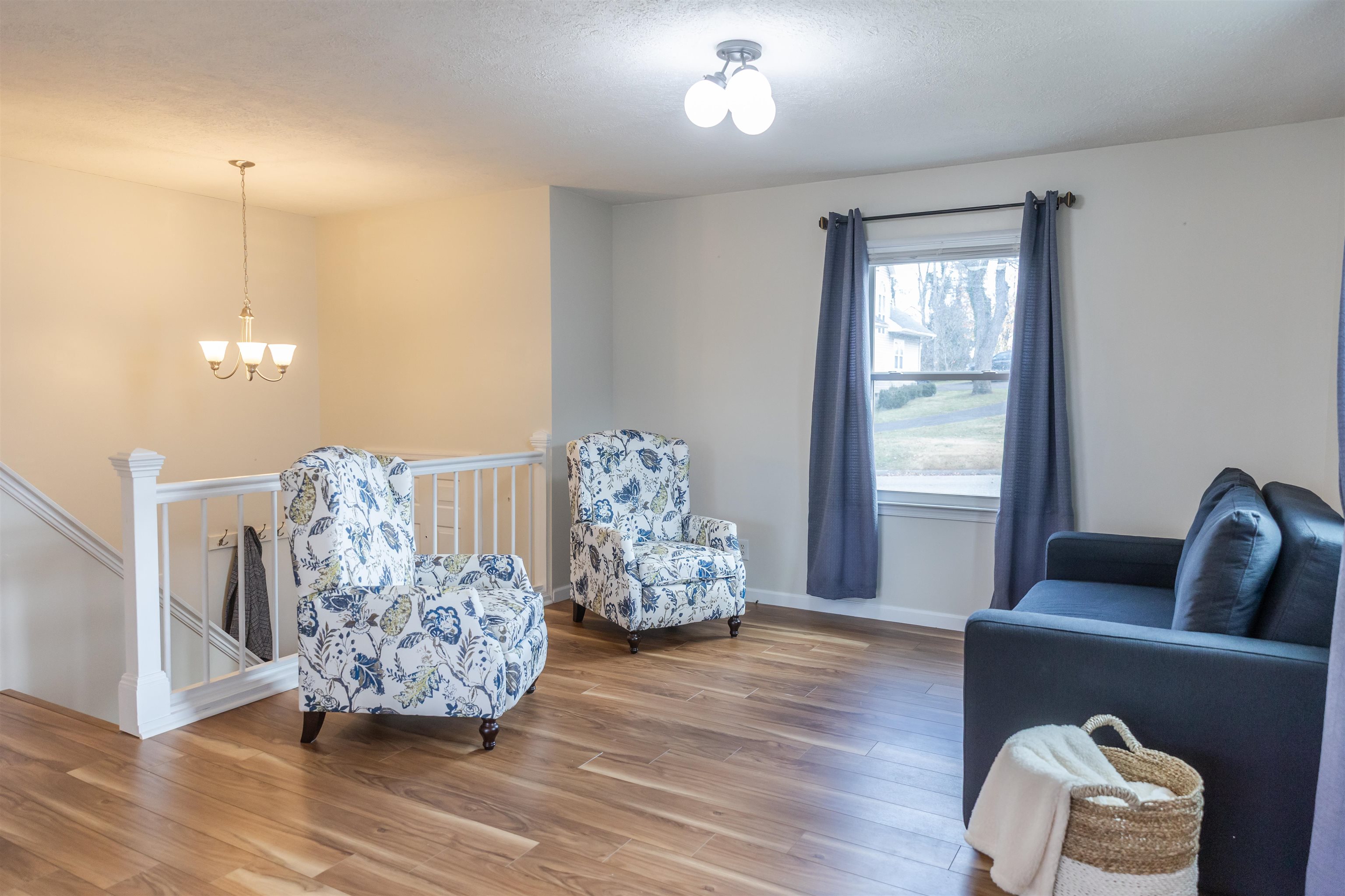 303 Summit Street Lexington, VA 24450 - Photo 24 of 58 a living room with furniture and a chandelier