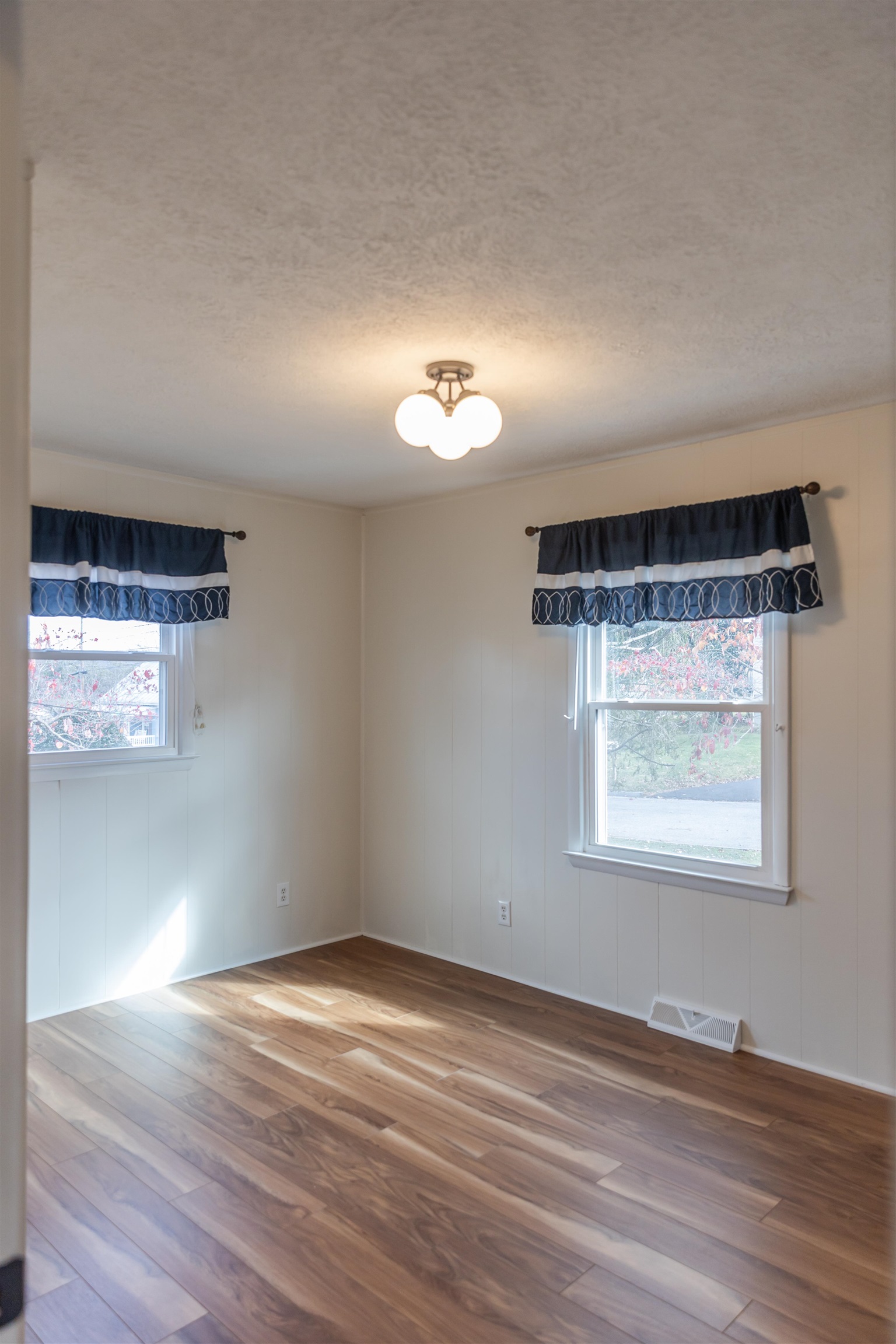 303 Summit Street Lexington, VA 24450 - Photo 30 of 58 an empty room with wooden floor and windows