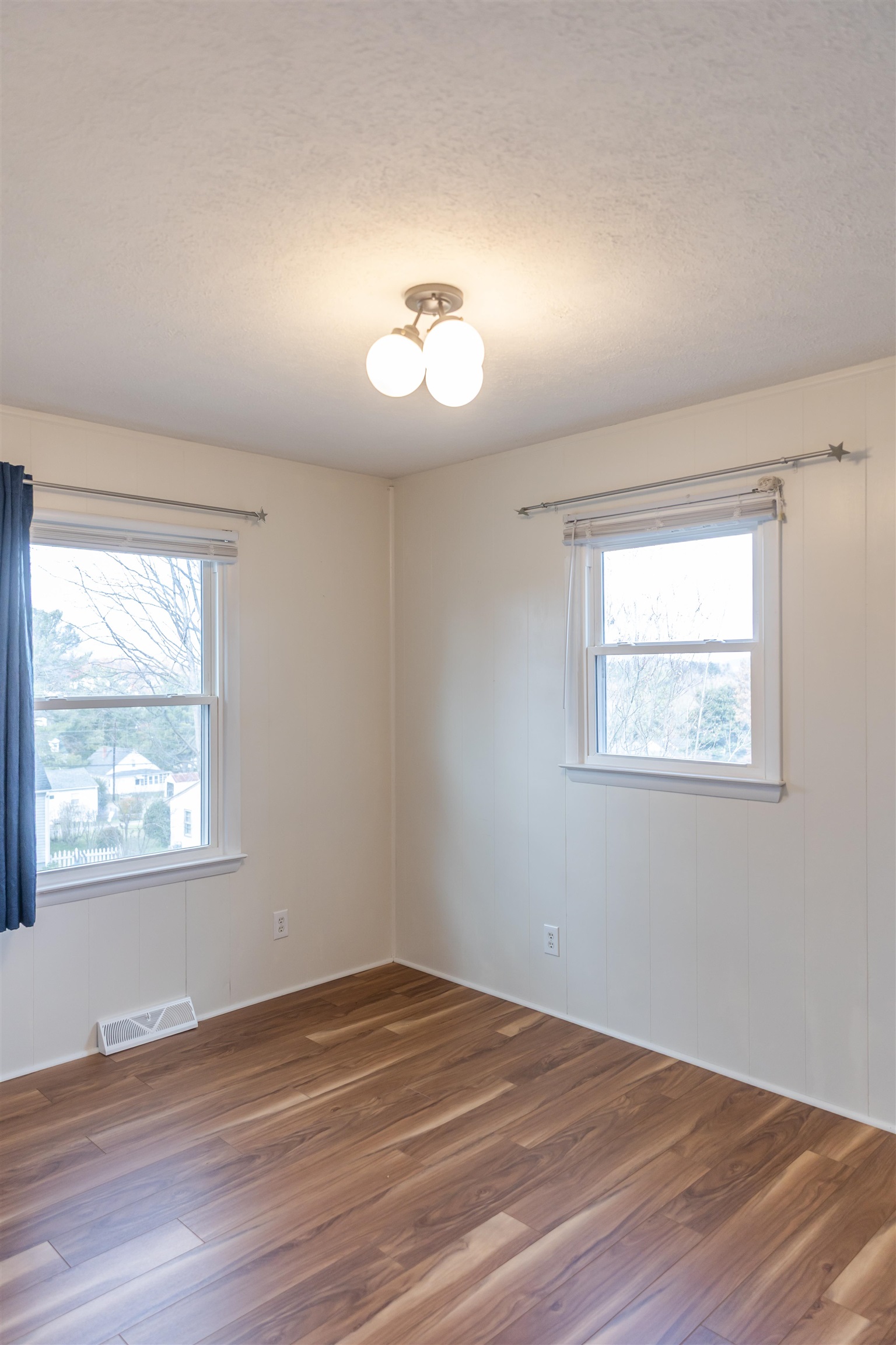 303 Summit Street Lexington, VA 24450 - Photo 35 of 58 an empty room with wooden floor and windows
