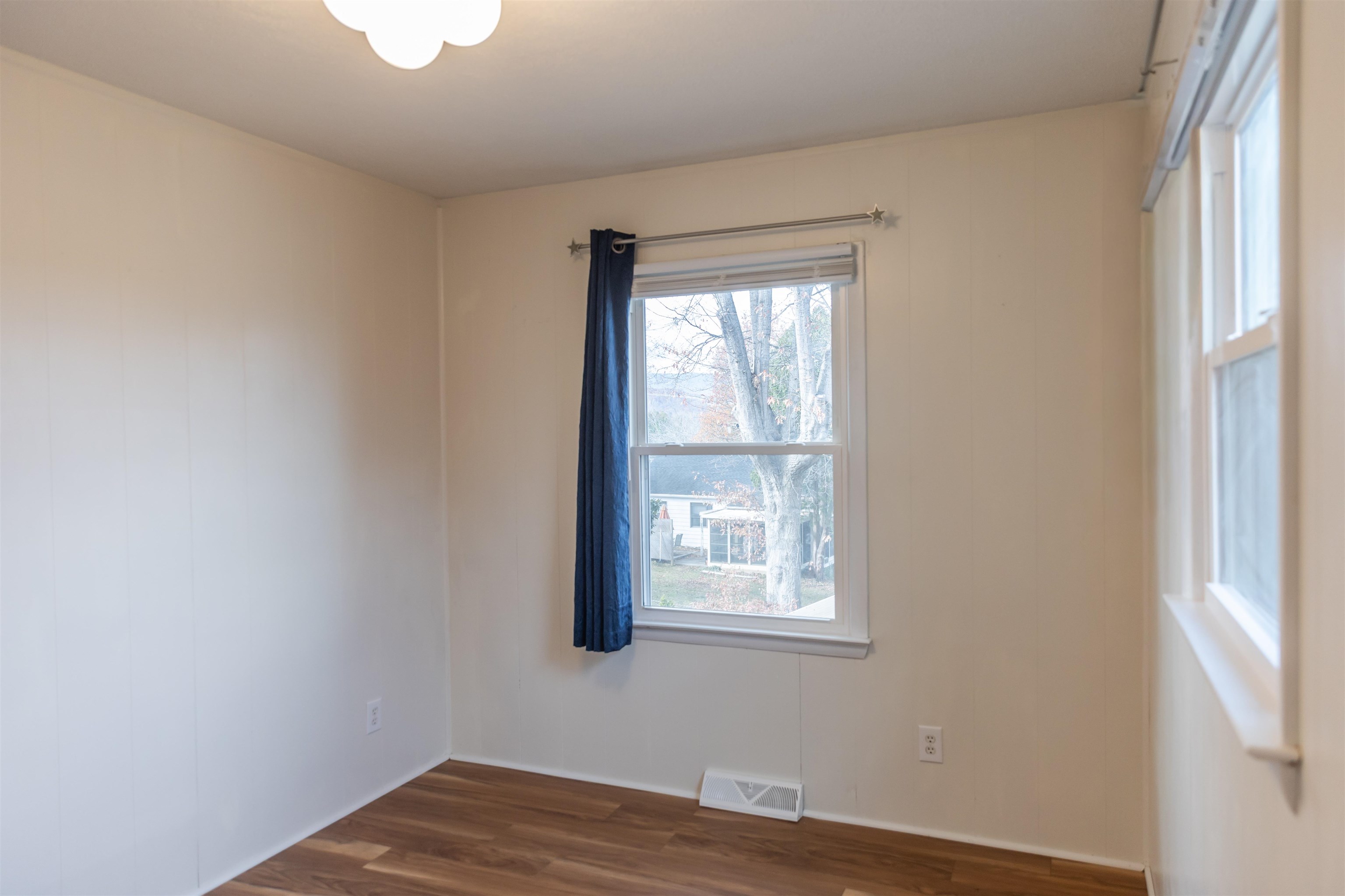 303 Summit Street Lexington, VA 24450 - Photo 36 of 58 a view of a bedroom with wooden floor and a window