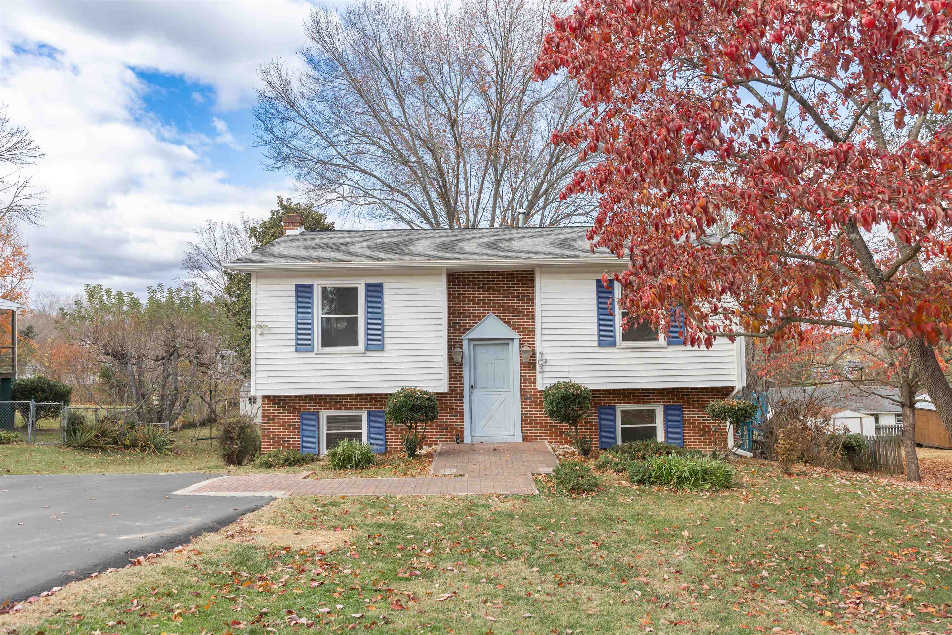 303 Summit Street Lexington, VA 24450 - Photo 6 of 58 a front view of a house with yard and trees