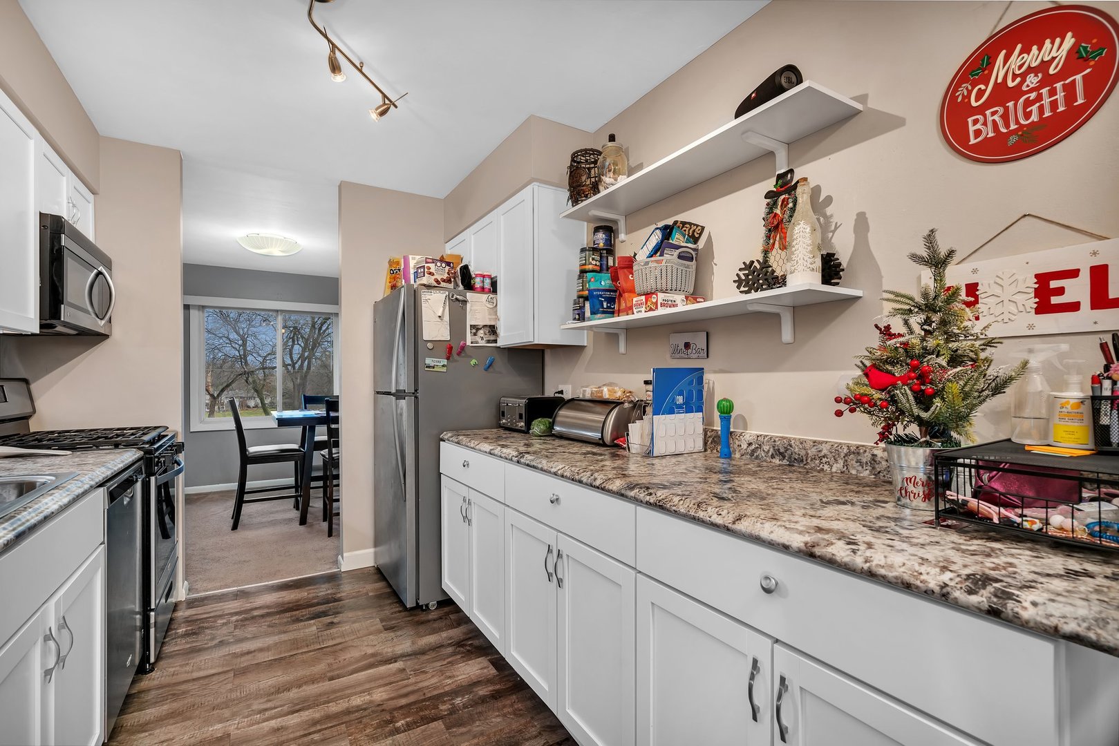 2811 Hobson Road, Unit 6 Woodridge, IL 60517 - Photo 7 of 21 a kitchen with granite countertop lots of clutter and stainless steel appliances