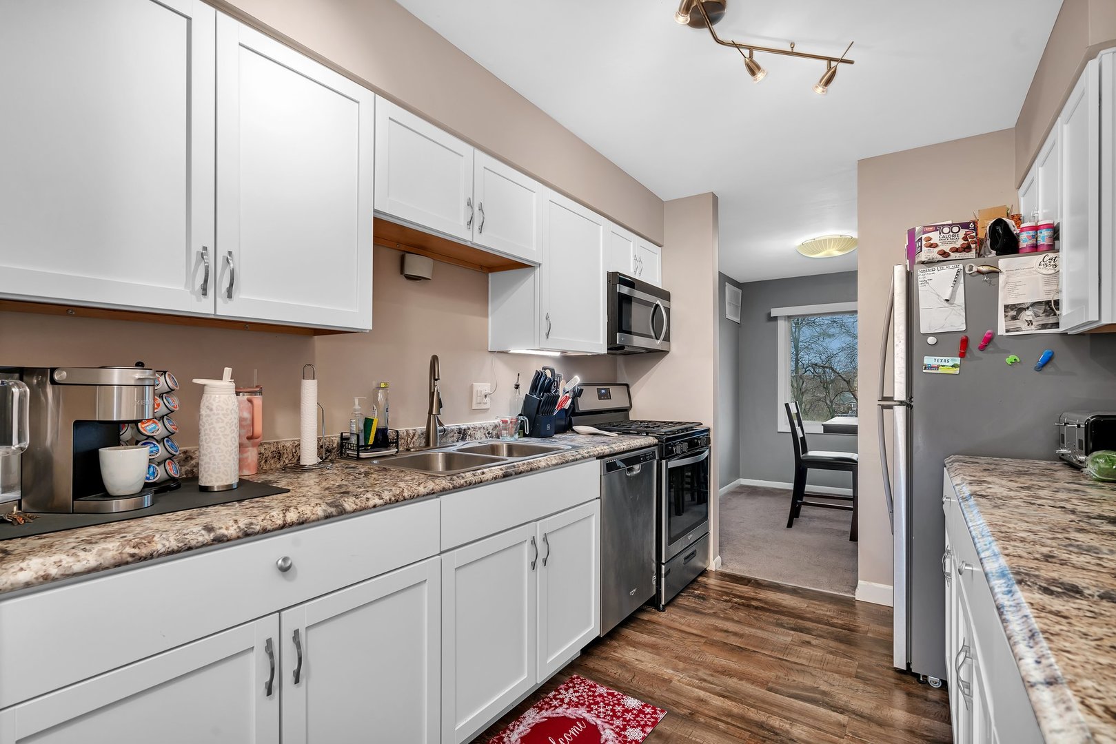 2811 Hobson Road, Unit 6 Woodridge, IL 60517 - Photo 8 of 21 a kitchen with granite countertop stainless steel appliances a sink dishwasher refrigerator stove and cabinets