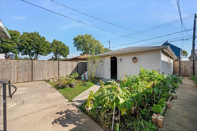 a backyard of a house with plants and trees
