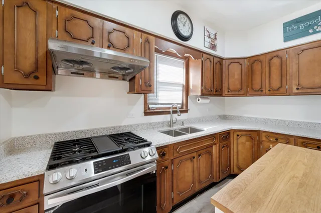 a kitchen with a stove and cabinets