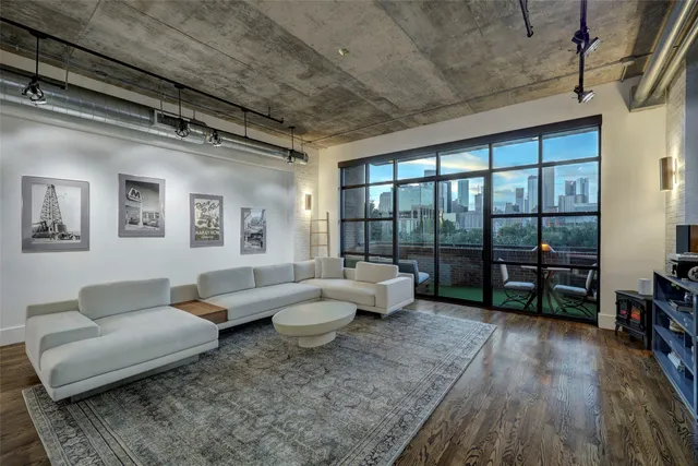 a living room with furniture and a floor to ceiling window