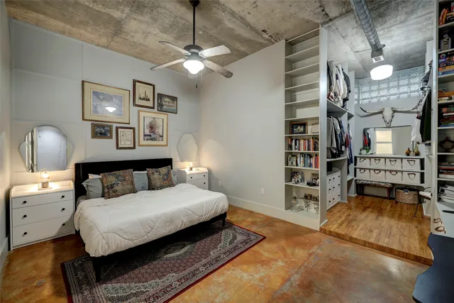 a bedroom with a large bed and a chandelier