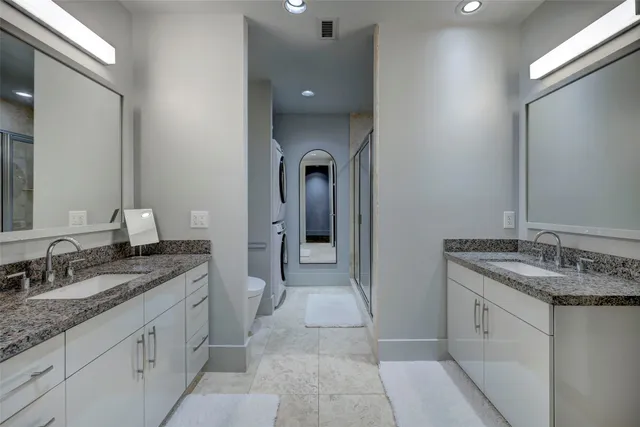 a spacious bathroom with a granite countertop sink and a mirror