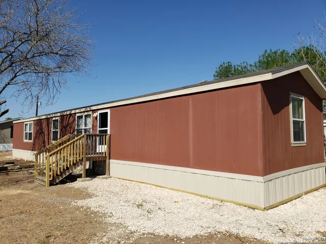 a backyard of a house with a tree