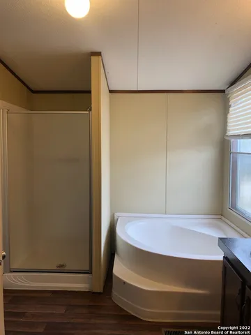 a bathroom with a tub sink and mirror