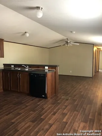 a kitchen with a sink and a stove top oven