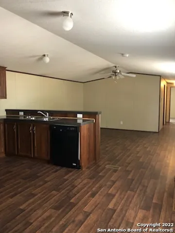 a kitchen with a sink and a stove top oven