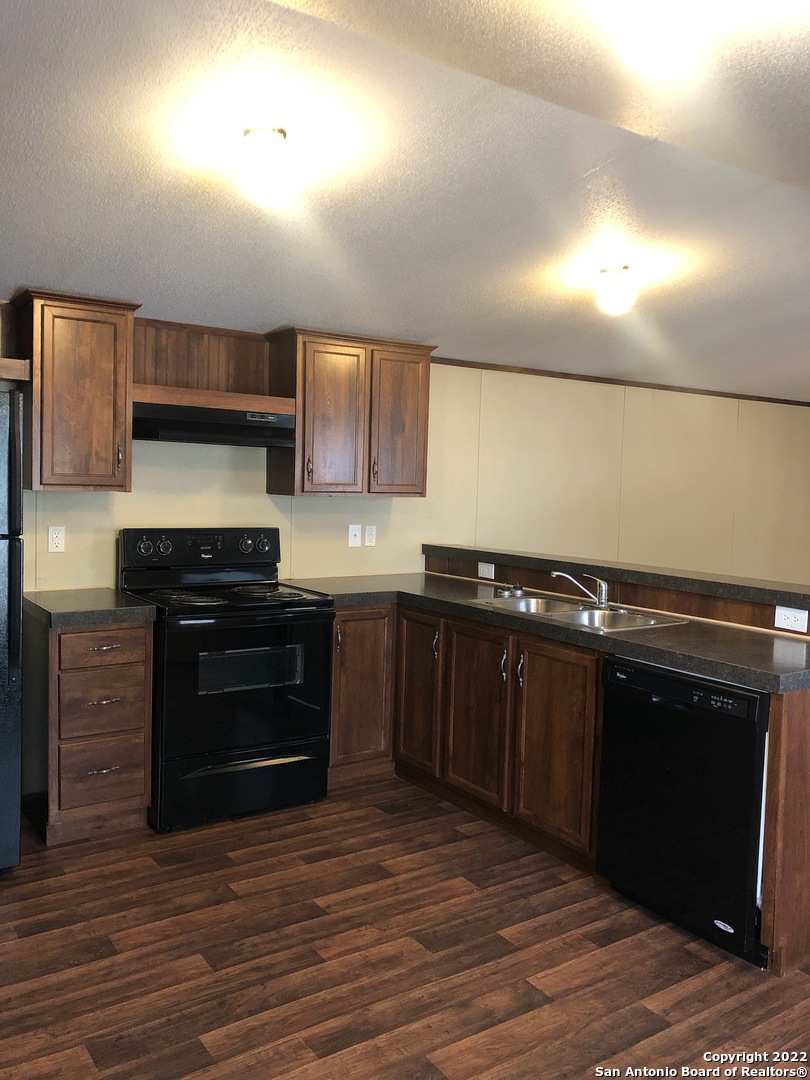 1914 14th Street, Unit 10 Hondo, TX 78861 - Photo 4 of 13 a kitchen with a sink and a stove top oven