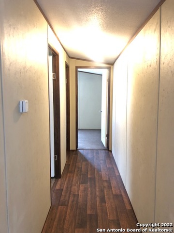 1914 14th Street, Unit 10 Hondo, TX 78861 - Photo 5 of 13 a view of a hallway with wooden floor