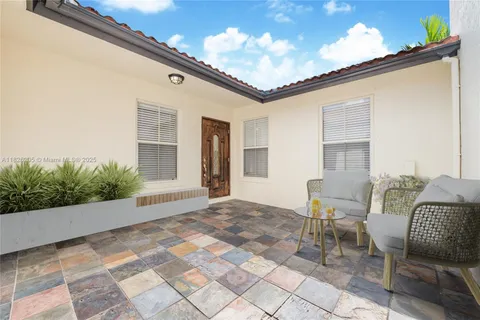 a balcony with furniture and a potted plant