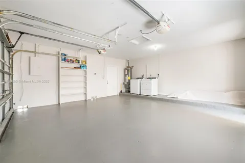 a view of empty room with wooden floor and white walls