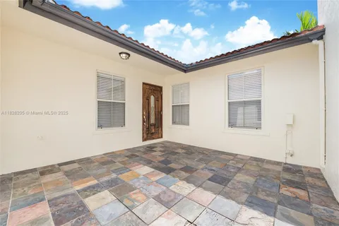 a view of a white house with a large window