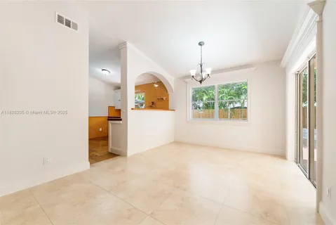 an empty room with windows and entrance