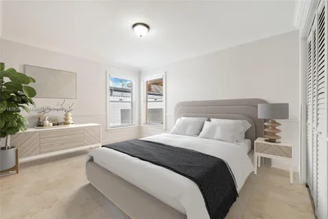 a spacious bedroom with a bed and a couch